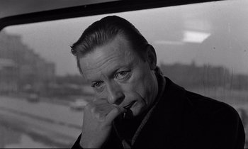Movie still from “Wings of Desire” (1987), directed by Wim Wenders – Black and white photograph of a man with a cigarette; Close Up shot, Over the shoulder angle