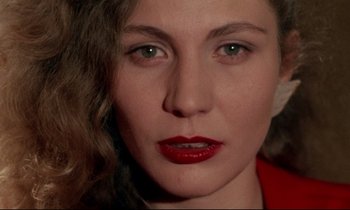 Movie still from “Wings of Desire” (1987), directed by Wim Wenders – A person with red lipstick; Close Up shot, High angle