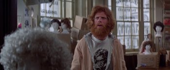 Movie still from “Winter Kills” (1979), directed by William Richert – A man with red hair and a red beard; Medium shot, Over the shoulder angle