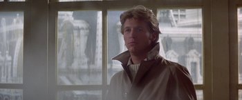Movie still from “Winter Kills” (1979), directed by William Richert – A man wearing a coat and a sweater; Close Up shot, Low angle
