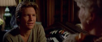 Movie still from “Winter Kills” (1979), directed by William Richert – A person sitting in front of a keyboard; Close Up shot, Over the shoulder angle