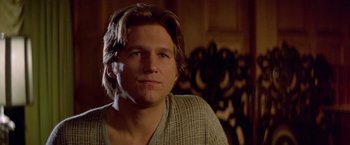 Movie still from “Winter Kills” (1979), directed by William Richert – A person with long hair; Close Up shot, Over the shoulder angle