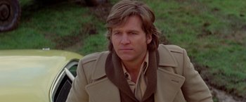 Movie still from “Winter Kills” (1979), directed by William Richert – A person wearing a jacket; Close Up shot, Low angle