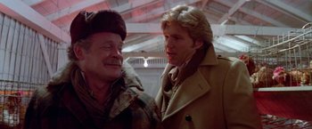 Movie still from “Winter Kills” (1979), directed by William Richert – A man and a woman talking to each other; Close Up shot, Over the shoulder angle