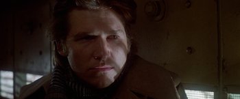 Movie still from “Winter Kills” (1979), directed by William Richert – A person wearing a jacket; Close Up shot, Low angle