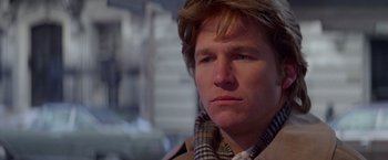 Movie still from “Winter Kills” (1979), directed by William Richert – A person wearing a jacket; Close Up shot, Over the shoulder angle