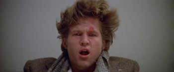 Movie still from “Winter Kills” (1979), directed by William Richert – A young man with a messy hair style; Close Up shot, Low angle