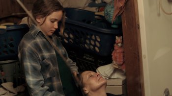 Movie still from “Winter's Bone” (2010), directed by Debra Granik – A woman and a girl are in a room; Medium shot, Over the shoulder angle