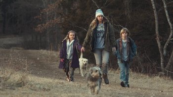Movie still from “Winter's Bone” (2010), directed by Debra Granik – A woman and two children walking with a dog; Medium shot, Over the shoulder angle