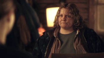 Movie still from “Winter's Bone” (2010), directed by Debra Granik – A woman in a green shirt and a brown jacket; Close Up shot, Over the shoulder angle