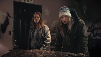 Movie still from “Winter's Bone” (2010), directed by Debra Granik – Two young women standing next to each other in a room; Medium shot, High angle
