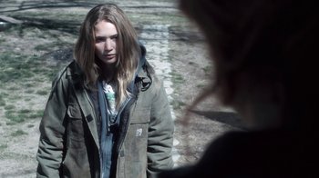 Movie still from “Winter's Bone” (2010), directed by Debra Granik – A young woman is standing on the sidewalk; Close Up shot, Over the shoulder angle
