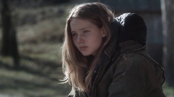 Movie still from “Winter's Bone” (2010), directed by Debra Granik – A young woman with long hair wearing a jacket; Close Up shot, High angle