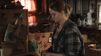 Movie still from “Winter's Bone” (2010), directed by Debra Granik – A woman painting a picture of a hand on a canvas; Medium shot, Over the shoulder angle