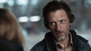 Movie still from “Winter's Bone” (2010), directed by Debra Granik – A person with a beard; Close Up shot, Over the shoulder angle