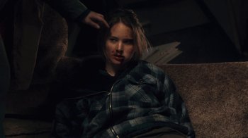 Movie still from “Winter's Bone” (2010), directed by Debra Granik – A woman sitting on a couch wrapped in a blanket; Close Up shot, Over the shoulder angle