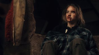 Movie still from “Winter's Bone” (2010), directed by Debra Granik – A young woman with a bruised face sitting on steps; Close Up shot, Over the shoulder angle