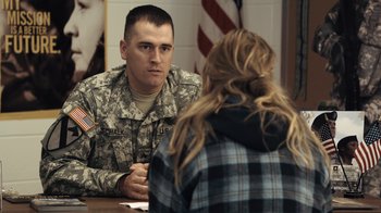 Movie still from “Winter's Bone” (2010), directed by Debra Granik – A man in a military fatigues sitting in front of a woman; Medium shot, Over the shoulder angle
