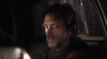 Movie still from “Winter's Bone” (2010), directed by Debra Granik – A person with a beard looking at the camera; Close Up shot, Over the shoulder angle