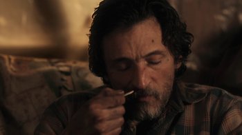 Movie still from “Winter's Bone” (2010), directed by Debra Granik – A person holding a spoon in his mouth; Close Up shot, Over the shoulder angle