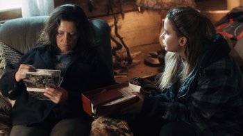 Movie still from “Winter's Bone” (2010), directed by Debra Granik – A woman and a young girl sitting in a room; Medium shot, Over the shoulder angle