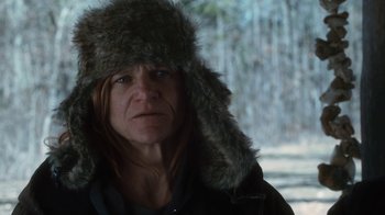 Movie still from “Winter's Bone” (2010), directed by Debra Granik – A woman wearing a fur hat and a black jacket; Close Up shot, Low angle