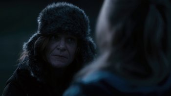 Movie still from “Winter's Bone” (2010), directed by Debra Granik – A woman wearing a fur hat looking at another woman; Close Up shot, Over the shoulder angle
