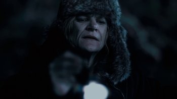 Movie still from “Winter's Bone” (2010), directed by Debra Granik – A woman wearing a fur hat and holding a flashlight; Close Up shot, Low angle