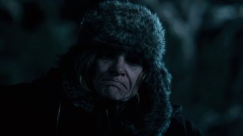 Movie still from “Winter's Bone” (2010), directed by Debra Granik – A man wearing a fur hat and a black jacket; Close Up shot, Low angle