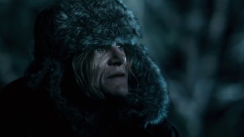 Movie still from “Winter's Bone” (2010), directed by Debra Granik – A man wearing a fur coat and a fur hat; Close Up shot, Over the shoulder angle