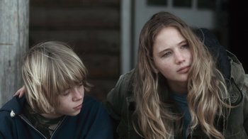 Movie still from “Winter's Bone” (2010), directed by Debra Granik – A young boy and a young girl sitting next to each other; Close Up shot, Over the shoulder angle