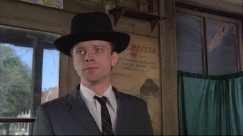 Movie still from “Wise Blood” (1979), directed by John Huston – A man wearing a suit and a black hat; Close Up shot, Low angle