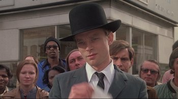 Movie still from “Wise Blood” (1979), directed by John Huston – A man in a suit and a black top hat; Close Up shot, Low angle