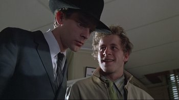 Movie still from “Wise Blood” (1979), directed by John Huston – Two men in suits and ties looking at each other; Close Up shot, Low angle
