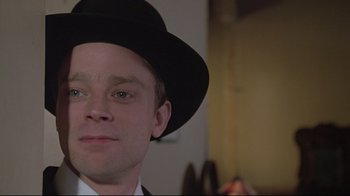 Movie still from “Wise Blood” (1979), directed by John Huston – A person wearing a hat; Close Up shot, Low angle