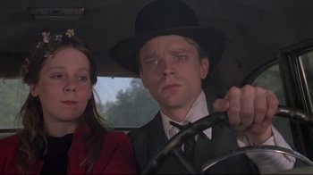 Movie still from “Wise Blood” (1979), directed by John Huston – A man and a woman sitting in the drivers seat of a car; Close Up shot, Low angle