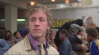 Movie still from “Wise Blood” (1979), directed by John Huston – A young man with curly blonde hair wearing a tie; Close Up shot, Low angle