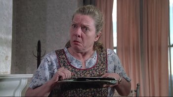 Movie still from “Wise Blood” (1979), directed by John Huston – An older woman is holding a plate in her hands; Close Up shot, Low angle