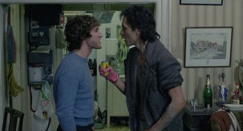 Movie still from “Withnail & I” (1987), directed by Bruce Robinson – Two young men are having a conversation in a kitchen; Medium shot, Over the shoulder angle
