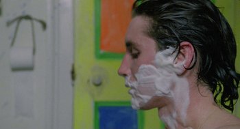 Movie still from “Withnail & I” (1987), directed by Bruce Robinson – A man with a shaving foam on his face; Close Up shot, Over the shoulder angle