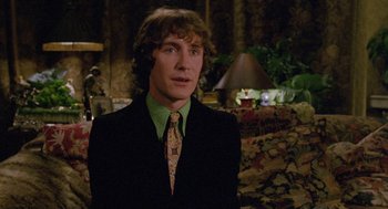 Movie still from “Withnail & I” (1987), directed by Bruce Robinson – A man in a suit and a green tie; Close Up shot, Low angle