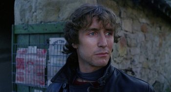 Movie still from “Withnail & I” (1987), directed by Bruce Robinson – A person wearing a leather jacket; Close Up shot, Low angle