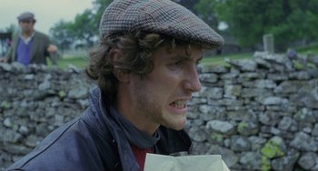 Movie still from “Withnail & I” (1987), directed by Bruce Robinson – A young man wearing a hat and a jacket; Close Up shot, Low angle