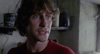 Movie still from “Withnail & I” (1987), directed by Bruce Robinson – A person wearing a red shirt; Close Up shot, Low angle
