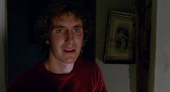 Movie still from “Withnail & I” (1987), directed by Bruce Robinson – A young man is looking into the camera; Close Up shot, Low angle