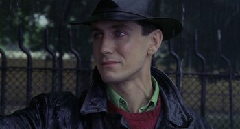 Movie still from “Withnail & I” (1987), directed by Bruce Robinson – A person wearing a hat and jacket; Close Up shot, Low angle