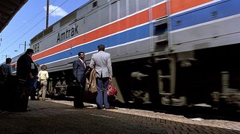 Movie still from “Witness” (1985), directed by Peter Weir – Two men standing on the side of a train track; Wide shot, Low angle