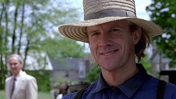 Movie still from “Witness” (1985), directed by Peter Weir – A person wearing a straw hat; Close Up shot, Low angle