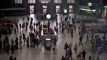 Movie still from “Witness” (1985), directed by Peter Weir – A crowd of people walking in a large building; Extreme Wide shot, High angle