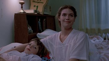 Movie still from “Witness” (1985), directed by Peter Weir – A woman sitting next to a child in a room; Close Up shot, Low angle